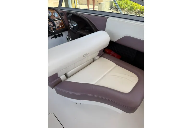 Slide: The Image of Interior of 2010 Cobalt 296 boat featuring a luxurious leather seat and dashboard. - 15