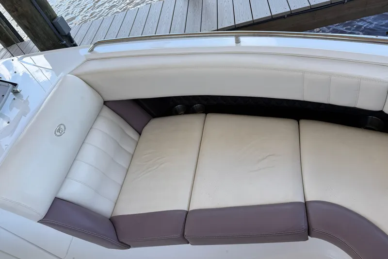 Slide: The Image of 2010 Cobalt 296 boat interior with white and gray cushioned seating. - 19