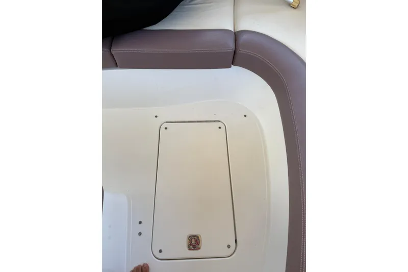 Slide: The Image of 2010 Cobalt 296 boat interior with cushioned seating and storage compartment. - 23