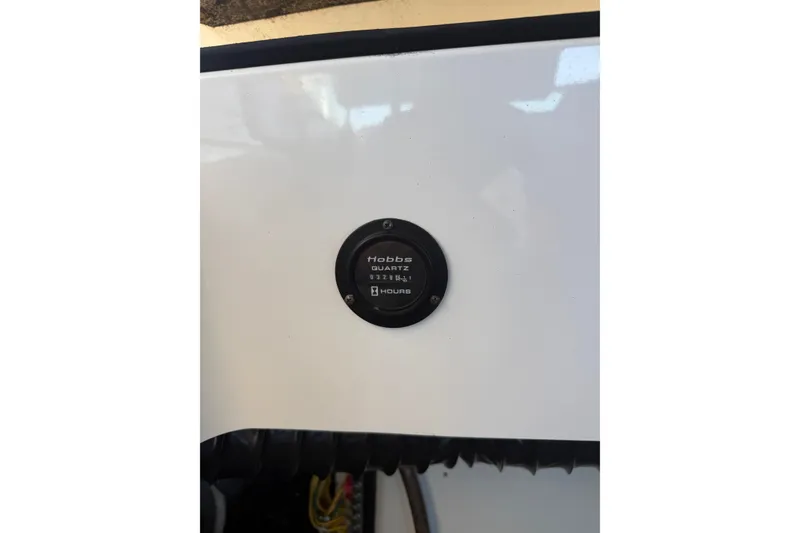 Slide: The Image of Hour meter on 2010 Cobalt 296 boat dashboard, displaying usage hours. - 27