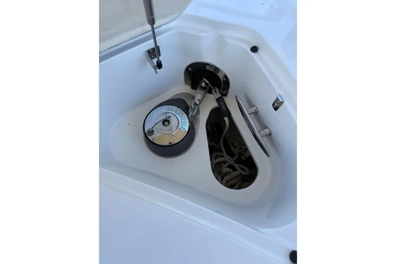 Slide: The Image of Anchor compartment of 2010 Cobalt 296 boat with winch and rope storage. - 28