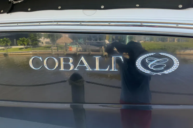 Slide: The Image of 2010 Cobalt 296 boat logo with reflection on glossy surface. - 3