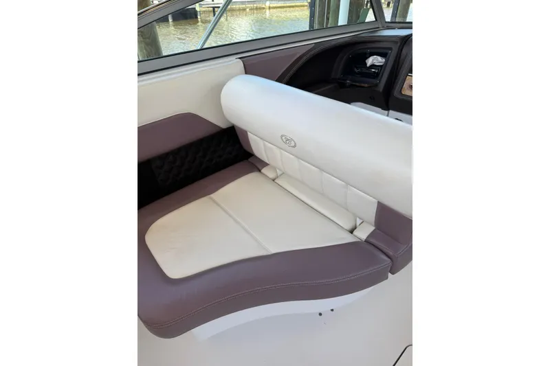 Slide: The Image of 2010 Cobalt 296 boat interior with cushioned seating and dashboard view. - 35