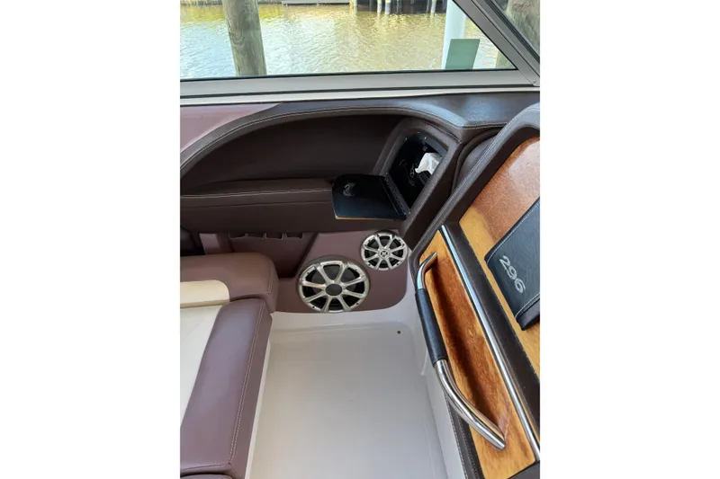Slide: The Image of Interior of 2010 Cobalt 296 boat with speaker and wood accents. - 38