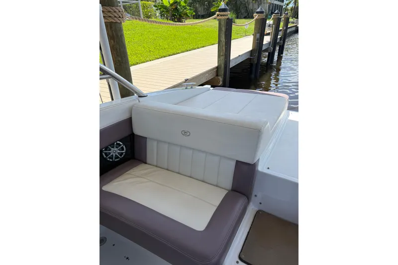 Slide: The Image of 2010 Cobalt 296 boat interior with cushioned seating by a dock. - 39