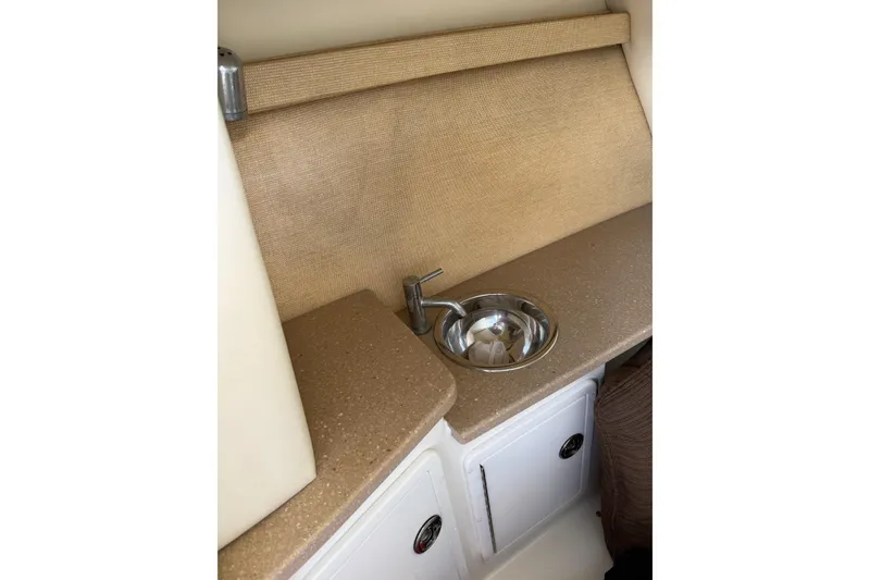 Slide: The Image of 2010 Cobalt 296 boat interior with compact sink and beige countertop. - 47