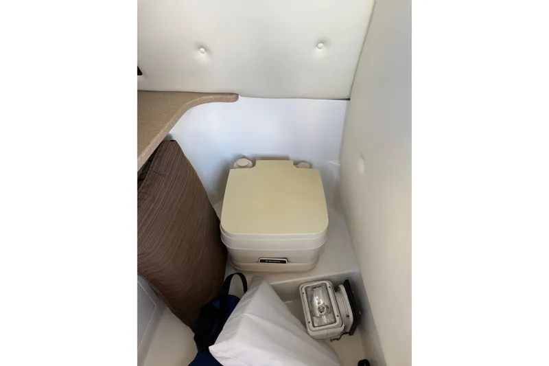 Slide: The Image of Compact marine toilet in 2010 Cobalt 296 boat interior. - 48