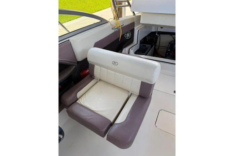 Slide: The Image of 2010 Cobalt 296 boat interior with cushioned seating and open storage compartment. - 6