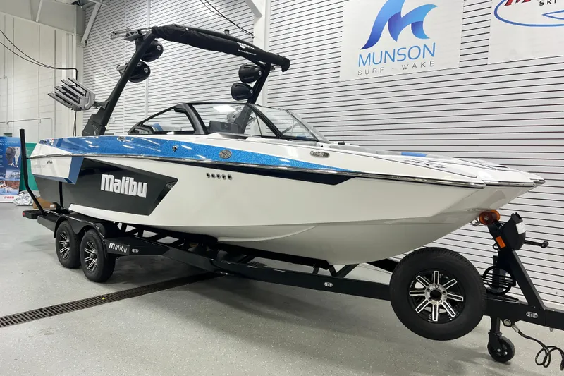 The Image of 2024 Malibu Wakesetter 24 MXZ boat on trailer in showroom. - 1