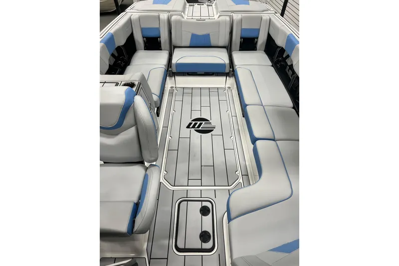 Slide: The Image of 2024 Malibu Wakesetter 24 MXZ interior with gray and blue seating, spacious layout. - 10