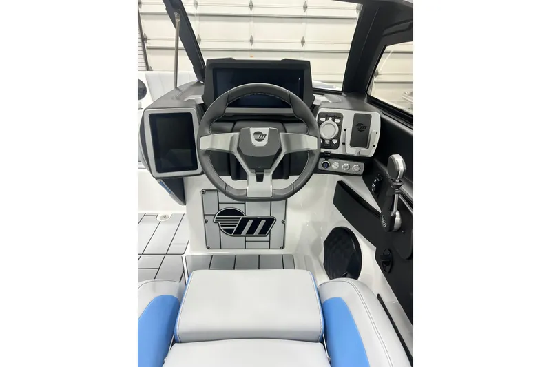 Slide: The Image of 2024 Malibu Wakesetter 24 MXZ boat dashboard with modern controls and steering wheel. - 14