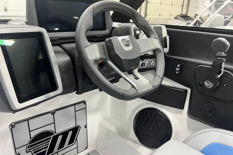 Slide: The Image of 2024 Malibu Wakesetter 24 MXZ dashboard with modern steering and digital displays. - 15