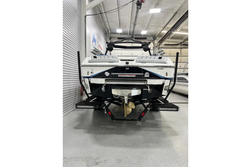 Slide: The Image of 2024 Malibu Wakesetter 24 MXZ boat in a showroom, rear view. - 3