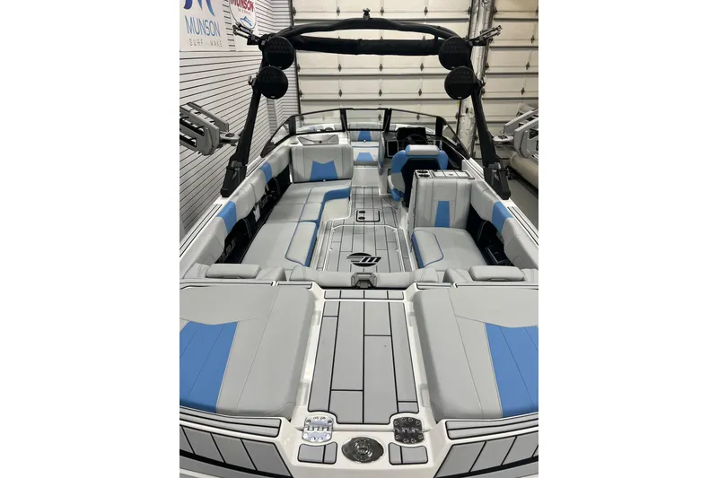 Slide: The Image of 2024 Malibu Wakesetter 24 MXZ boat interior with blue and gray seating. - 4