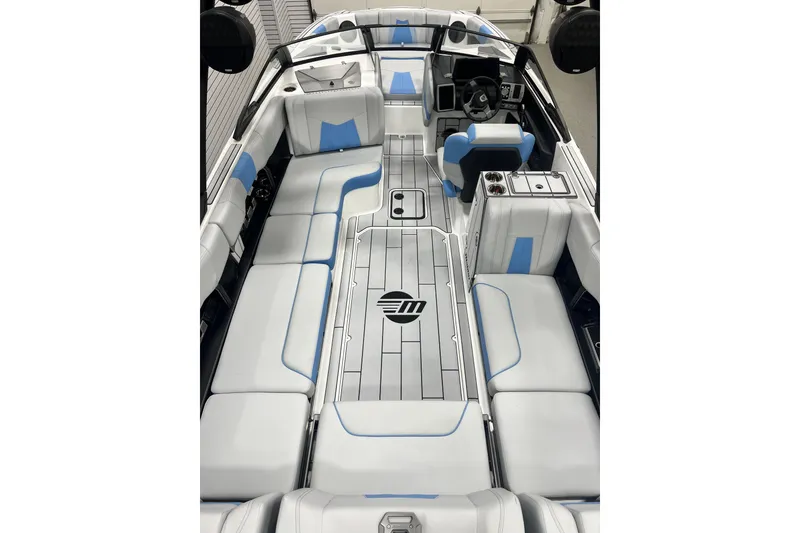 Slide: The Image of 2024 Malibu Wakesetter 24 MXZ interior with sleek white and blue seating design. - 5