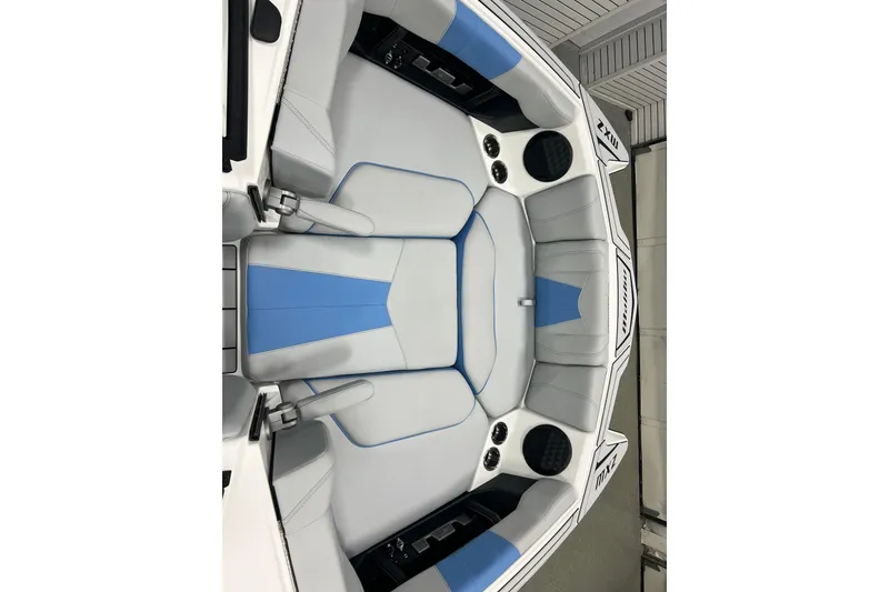Slide: The Image of 2024 Malibu Wakesetter 24 MXZ boat interior with blue and gray seating. - 7