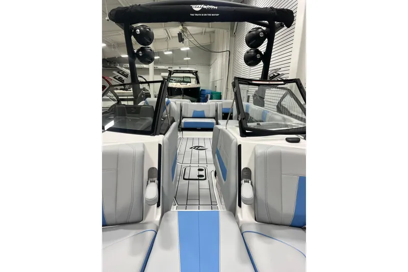 Slide: The Image of 2024 Malibu Wakesetter 24 MXZ interior with blue and gray seating, modern design. - 9