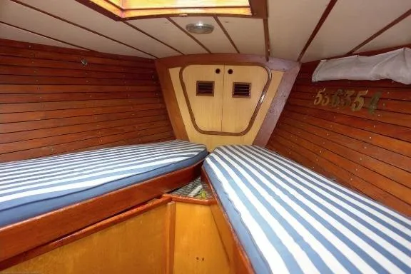 Slide: The Image of Interior of 1971 Nautor Swan 43 Sloop with striped cushions and wooden paneling. - 10