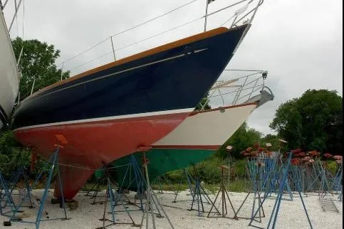 Slide: The Image of 1971 Nautor Swan 43 Sloop sailboats on stands, displayed outdoors. - 13