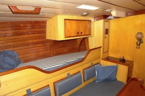 Slide: The Image of Interior of 1971 Nautor Swan 43 Sloop with wooden paneling and cozy seating. - 2