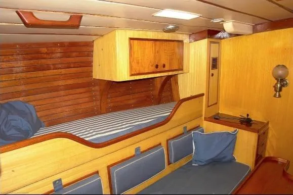 Slide: The Image of Interior of 1971 Nautor Swan 43 Sloop with wooden paneling and cozy sleeping area. - 5