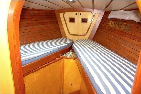 Slide: The Image of Interior cabin of 1971 Nautor Swan 43 Sloop with striped bedding and wooden paneling. - 9