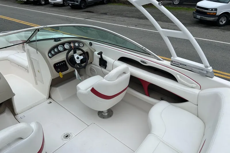 Slide: The Image of 2000 Chaparral 216 SSi boat interior with white seating and dashboard controls. - 22