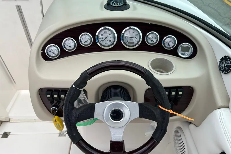 Slide: The Image of Steering console of a 2000 Chaparral 216 SSi boat with gauges and controls. - 25