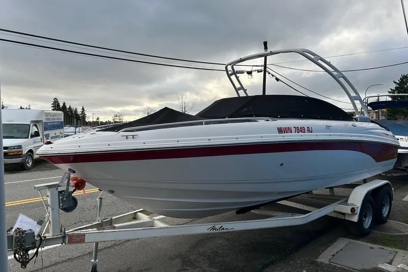 Slide: The Image of 2000 Chaparral 216 SSi boat on trailer, parked outdoors under cloudy sky. - 28