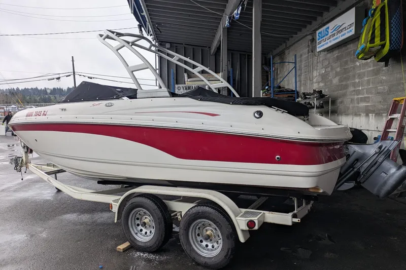 Slide: The Image of 2000 Chaparral 216 SSi boat on trailer in a marina setting. - 29