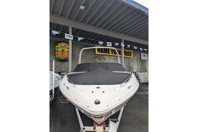 Slide: The Image of Chaparral 216 SSi 2000 boat under shelter with "Name Your Price" sign. - 31