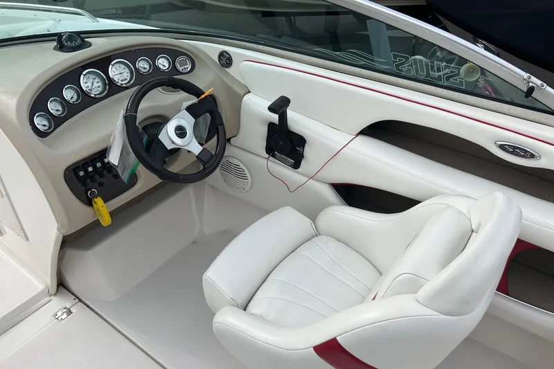 Slide: The Image of 2000 Chaparral 216 SSi boat on trailer, parked in a covered area. - 4