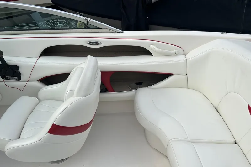 Slide: The Image of Interior view of a 2000 Chaparral 216 SSi boat dashboard with cup holder. - 9