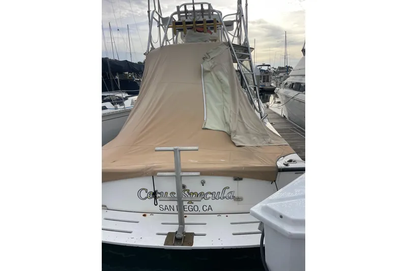 Slide: The Image of 1999 Albemarle 30 boat docked in San Diego, covered with beige tarp. - 1