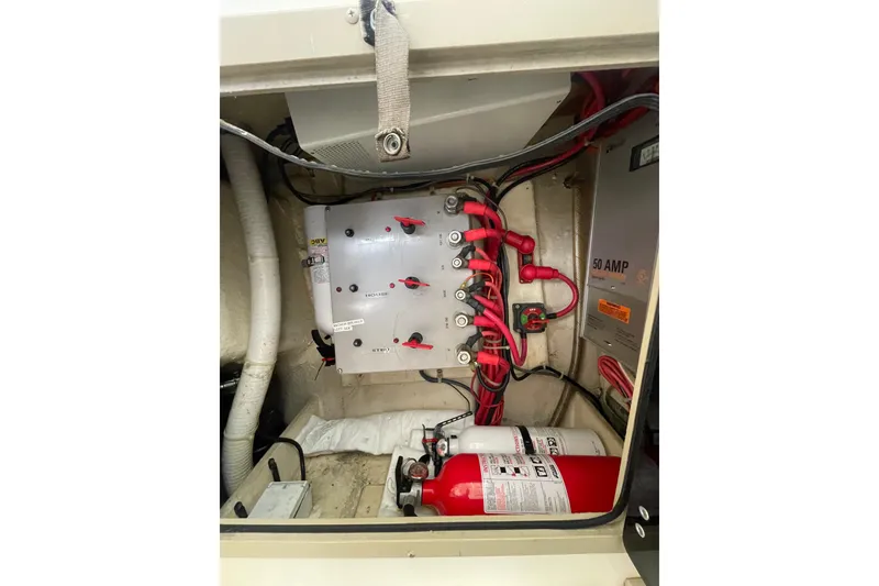 Slide: The Image of 1999 Albemarle 30 boat electrical panel with wiring and fire extinguisher. - 10