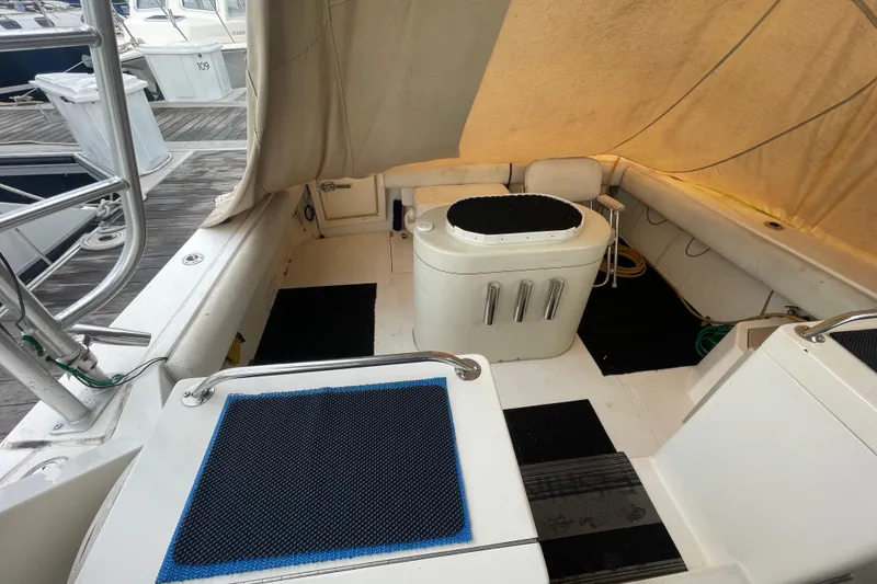 Slide: The Image of 1999 Albemarle 30 boat interior with seating and covered deck at marina. - 13