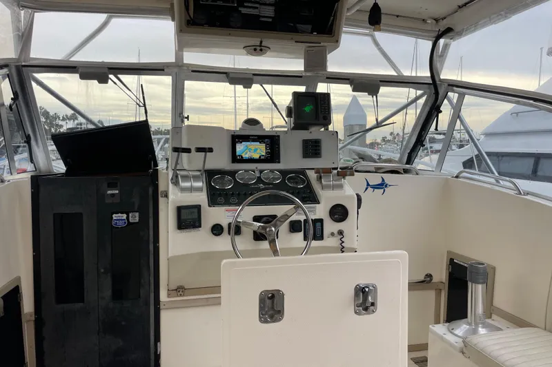 Slide: The Image of 1999 Albemarle 30 boat cockpit with navigation equipment and steering wheel. - 17