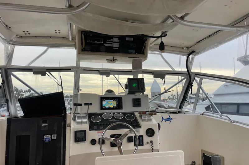 Slide: The Image of 1999 Albemarle 30 boat cockpit with navigation equipment and steering wheel. - 18