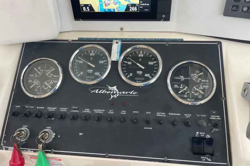 Slide: The Image of Instrument panel of a 1999 Albemarle 30 boat with gauges and controls. - 2