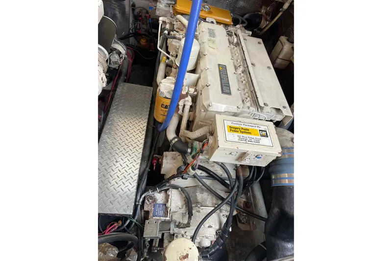 Slide: The Image of Engine compartment of a 1999 Albemarle 30 boat with visible components and wiring. - 21