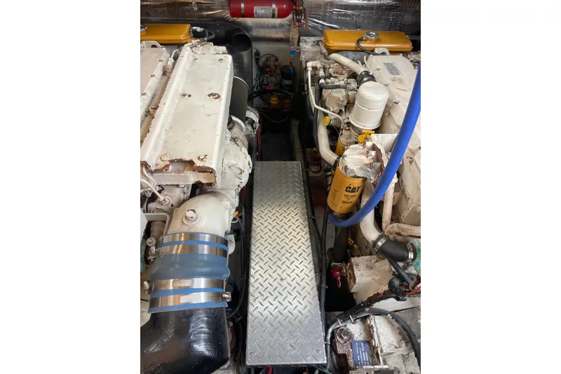Slide: The Image of Engine compartment of a 1999 Albemarle 30 boat, featuring dual engines and CAT filter. - 23