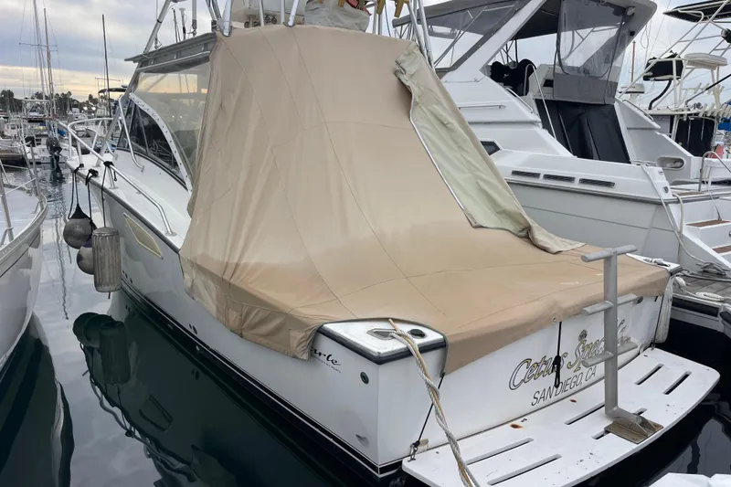 Slide: The Image of 1999 Albemarle 30 boat docked with beige cover, San Diego marina. - 33