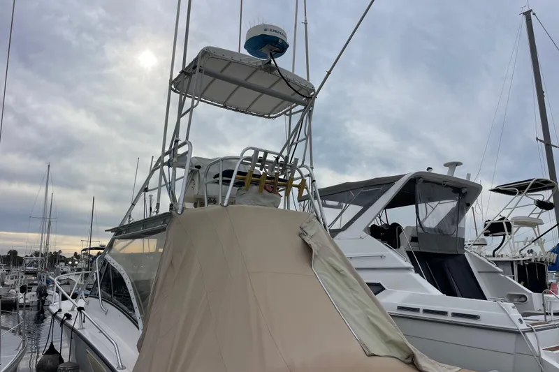 Slide: The Image of 1999 Albemarle 30 boat docked at marina under cloudy sky. - 34