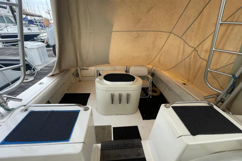 Slide: The Image of 1999 Albemarle 30 boat interior with seating and covered deck at marina. - 5