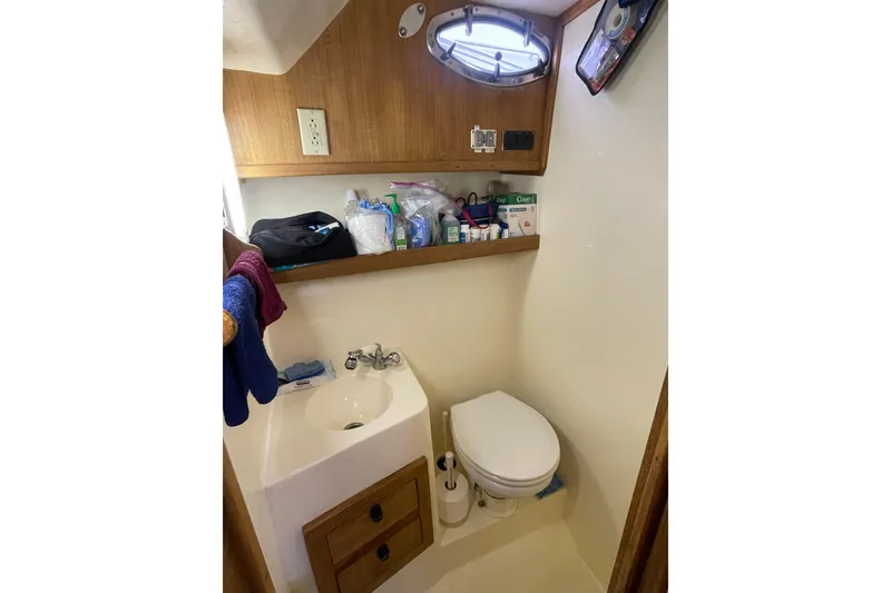 Slide: The Image of Bathroom interior of 1999 Albemarle 30 boat with sink, toilet, and storage shelves. - 8