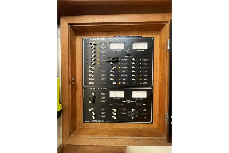 Slide: The Image of Electrical panel of a 1999 Albemarle 30 boat, featuring 12V DC and 240V AC systems. - 9