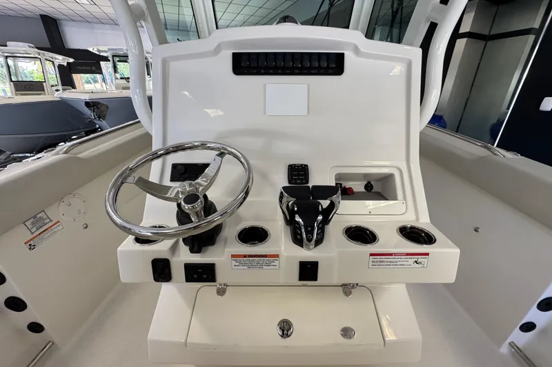 Slide: The Image of 2026 Sailfish 272 CC boat console with steering wheel and controls. - 1