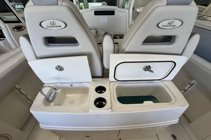 Slide: The Image of 2026 Sailfish 272 CC boat interior with sink, storage, and cup holders. - 3