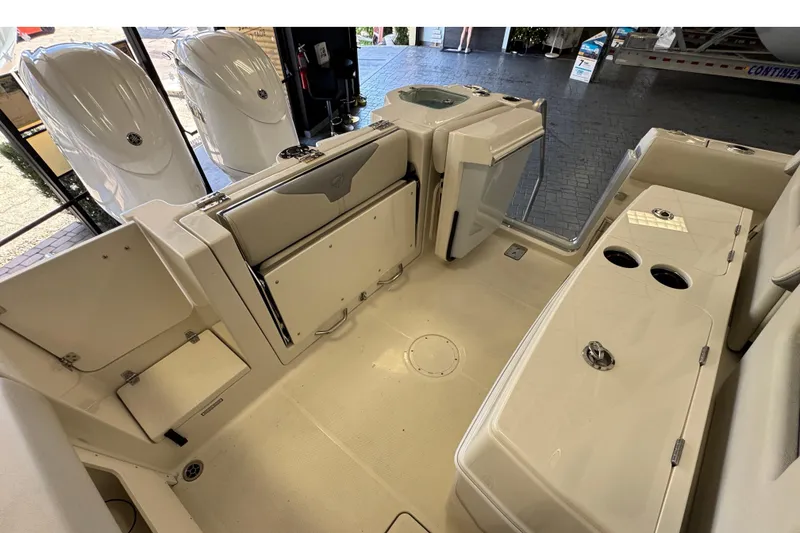 Slide: The Image of 2026 Sailfish 272 CC boat interior with seating, storage, and dual outboard motors. - 4