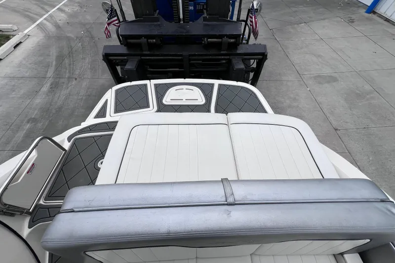 Slide: The Image of 2010 Sea Ray 220 Sundeck boat on a trailer, featuring cushioned seating and deck details. - 12